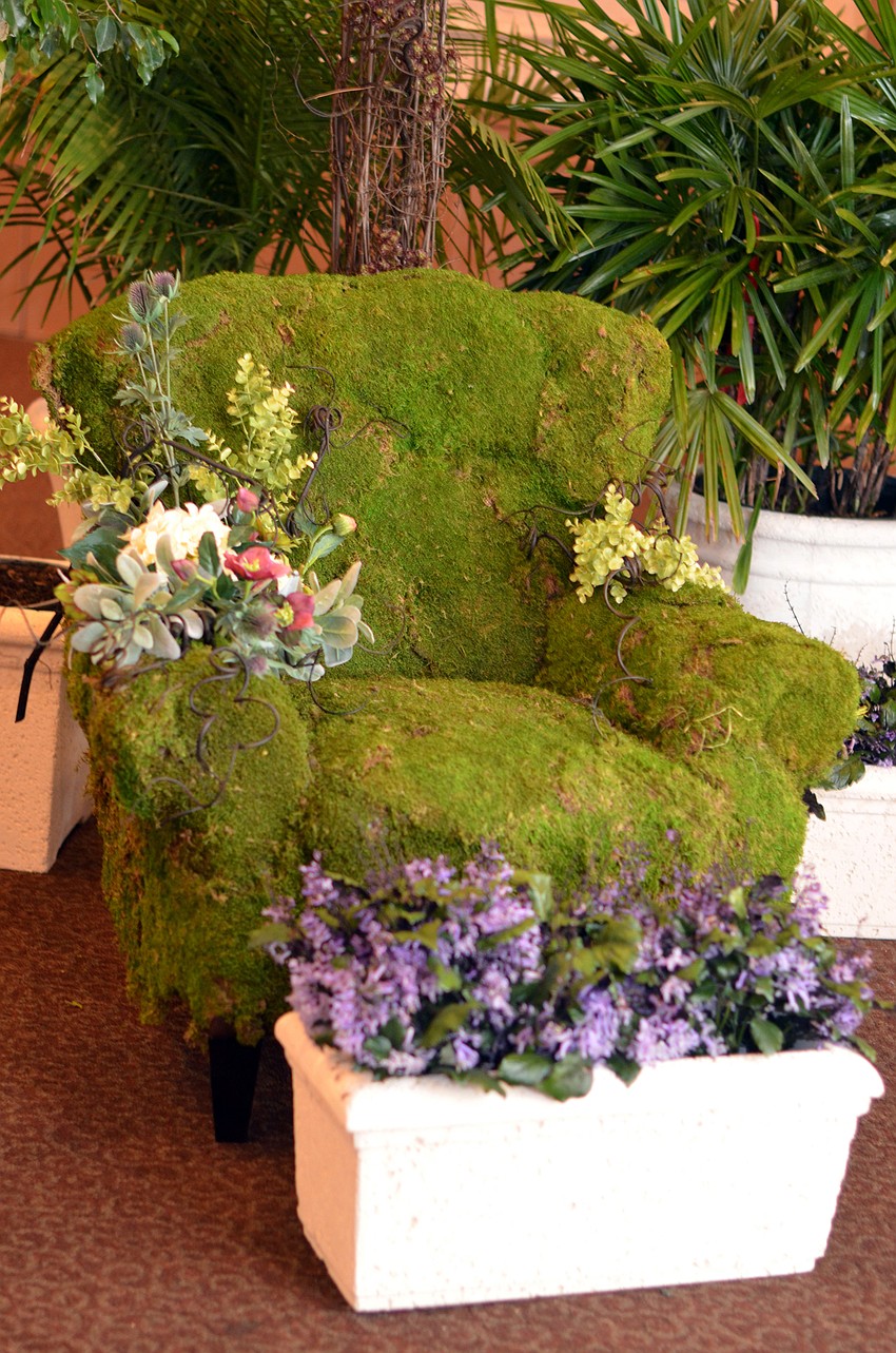 A chair decorated with moss and flowers was part of the decor for Historic Spanish Point's 'An Enchanted Luncheon.'