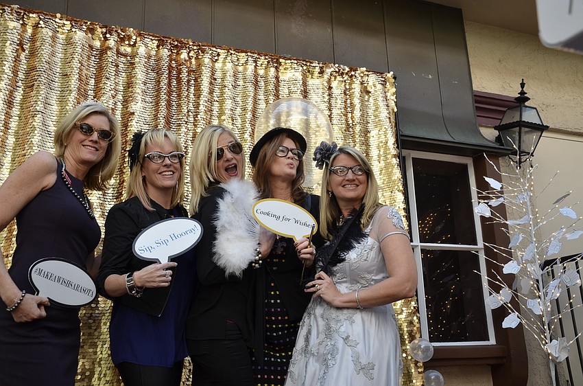 Beth Knopik, Susan Jones, Michelle Butler, Renee Phinney and Fran LaCivita have fun in the photo booth.