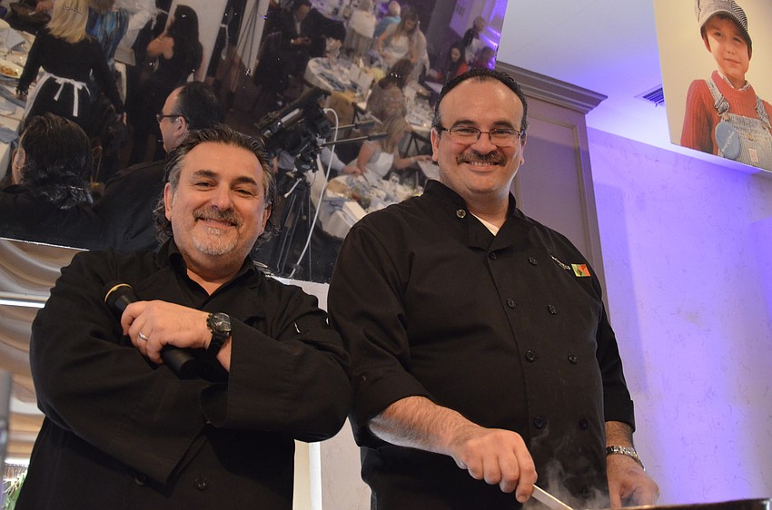 Phil Mancini and Jamil Pineda call out instructions to the table chefs.