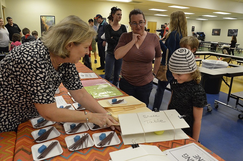 Engineering teacher Sue Curry explains to Naomi and Tara Moran they need to make a structure that can withstand an 