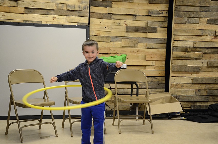 Avery Fulk whirls a hula hoop as fast as he can.