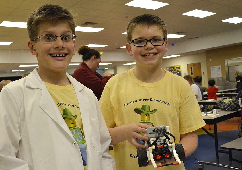 Alex Denboggende and Justin Cangro helped kids at the robotics station. The fourth-graders are on the Wrangler Bots First Lego League.