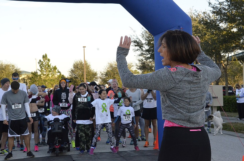 Brenda Moore of Crunch Fitness helps runners warm up.