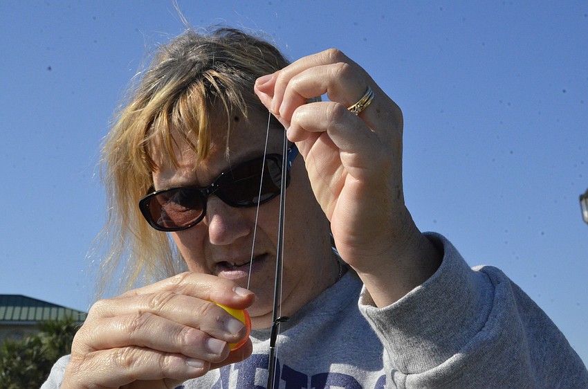 Karla Owens of Ellenton helps with her daughter Elizabeth's rod.