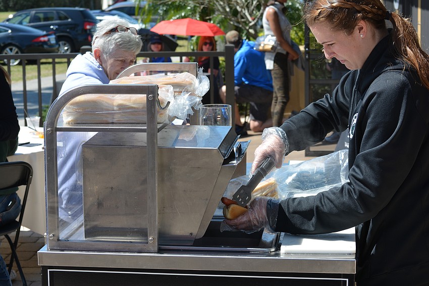 Lakewood Ranch High School student Emma Freeman, a member of the National Honor Society,  donated her time serving hot dogs.