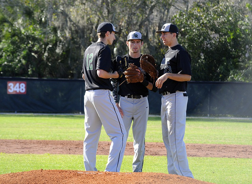 Lakewood Ranch's Matt Ambrosino, Connor Hetterich and Colton Zimring huddle together before the start of the bottom of the first inning.