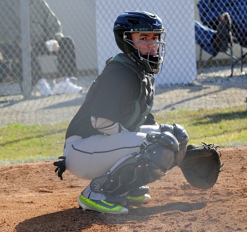Lakewood Ranch catcher AJ Rizzo looks to the bench for the sign.
