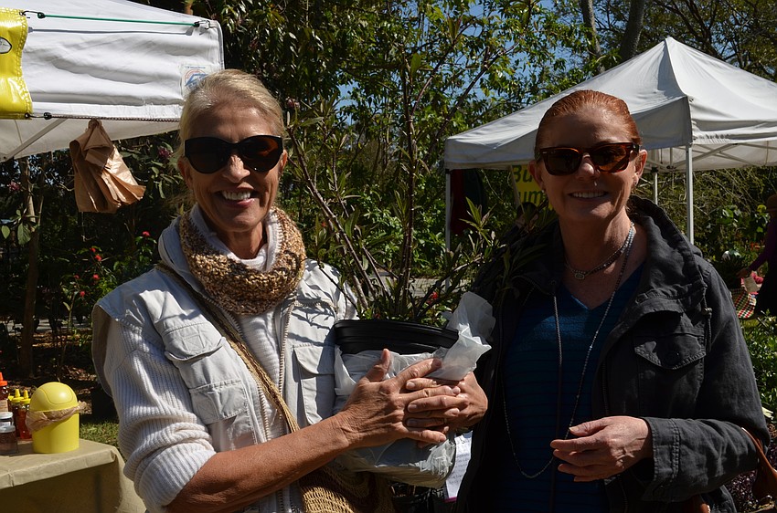 Annarita Scott and Julia Park with their purchase of milkweed. Scott is hoping to start a butterfly garden at her home.