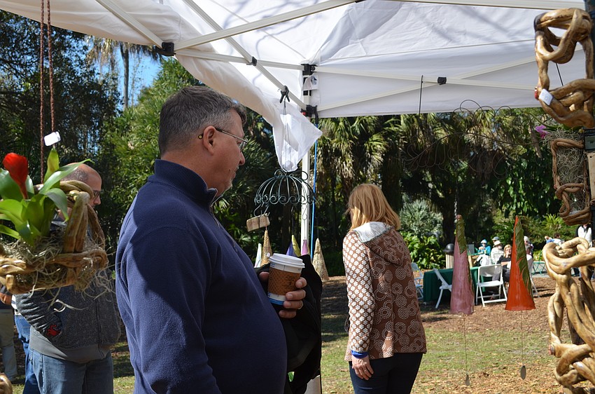Joe Sass browses the eclectic pottery on sale.