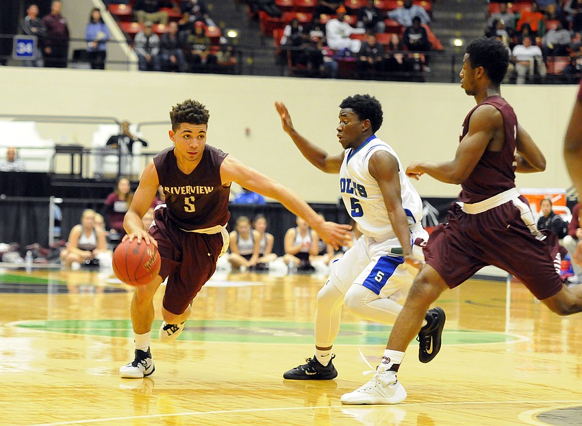 Riverview point guard D.J. Bryant pushes the ball past Coral Springs' Chris Lucien.