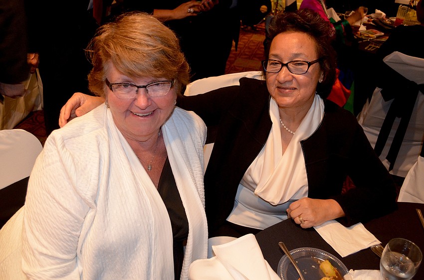 Darlene Pineivero and Mara Mingledorff wait for dinner and dancing to begin.