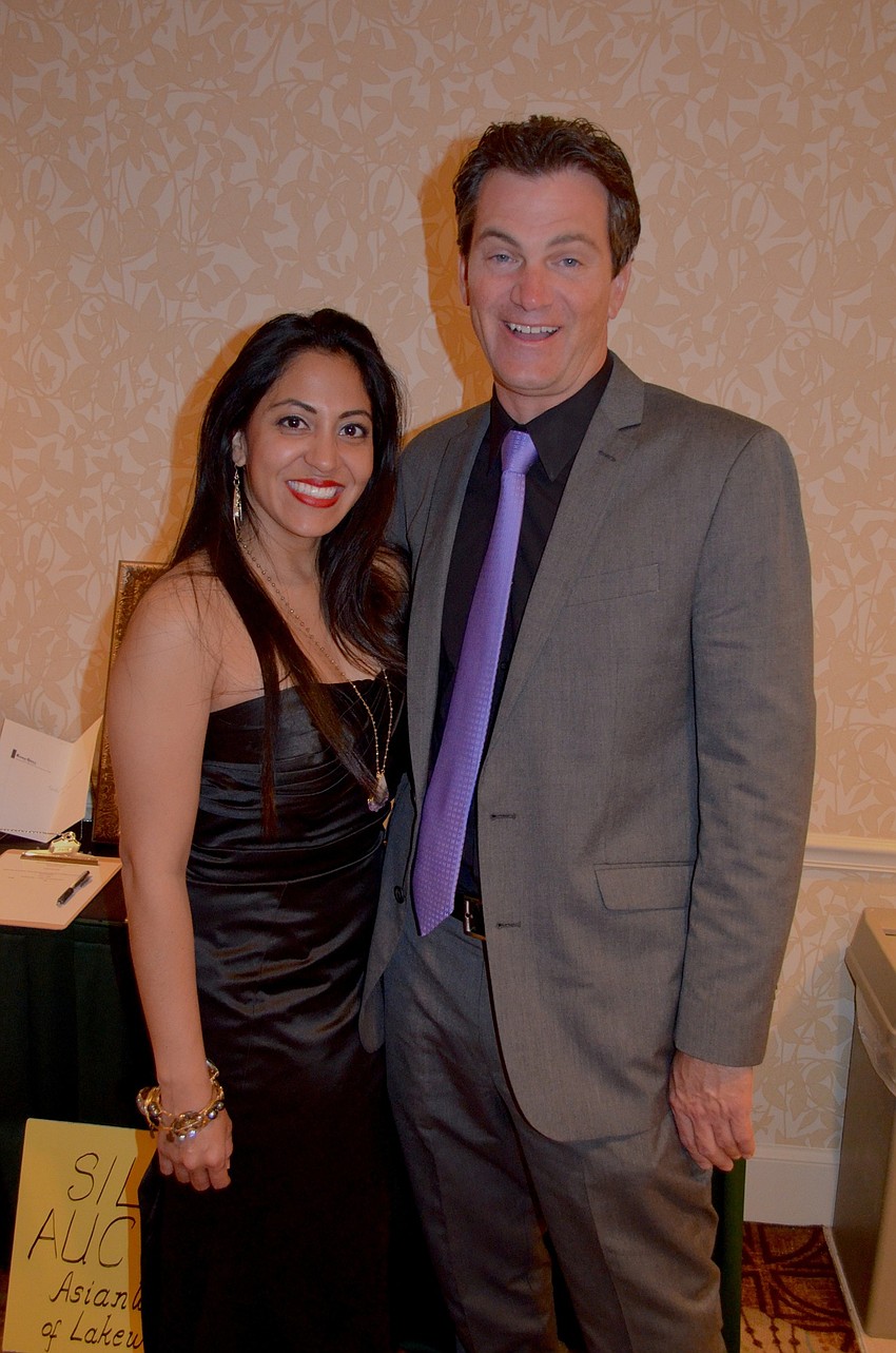 Jessica Caycedo and Michael Morgan share laughs near the snack table.
