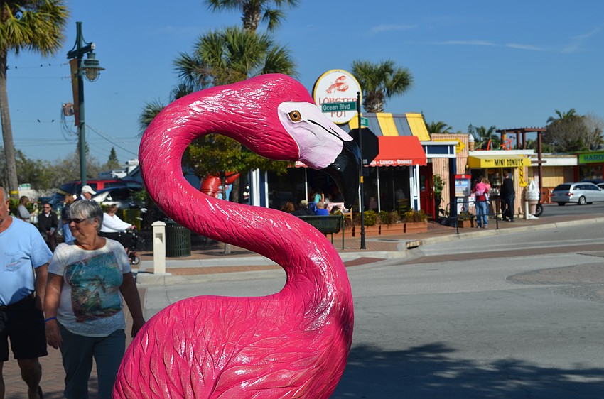 A wooden carving of a flamingo by artist Ademir Borges fits right in at the intersection of Ocean Boulevard and Avenida Messina.