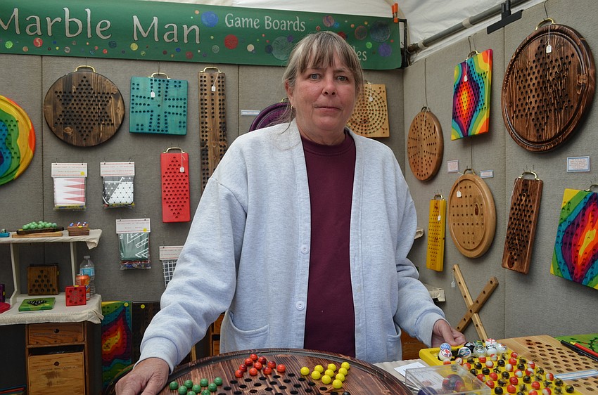 Sue Hahn's tent for The Marble Man offers classic games like Chinese Checkers and Mancala played with marbles made from recycled glass.