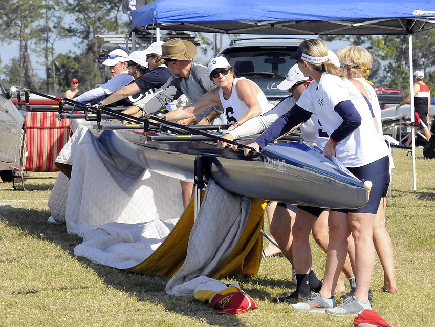 Members of the Sarasota Crew masters program pack up one their boats.