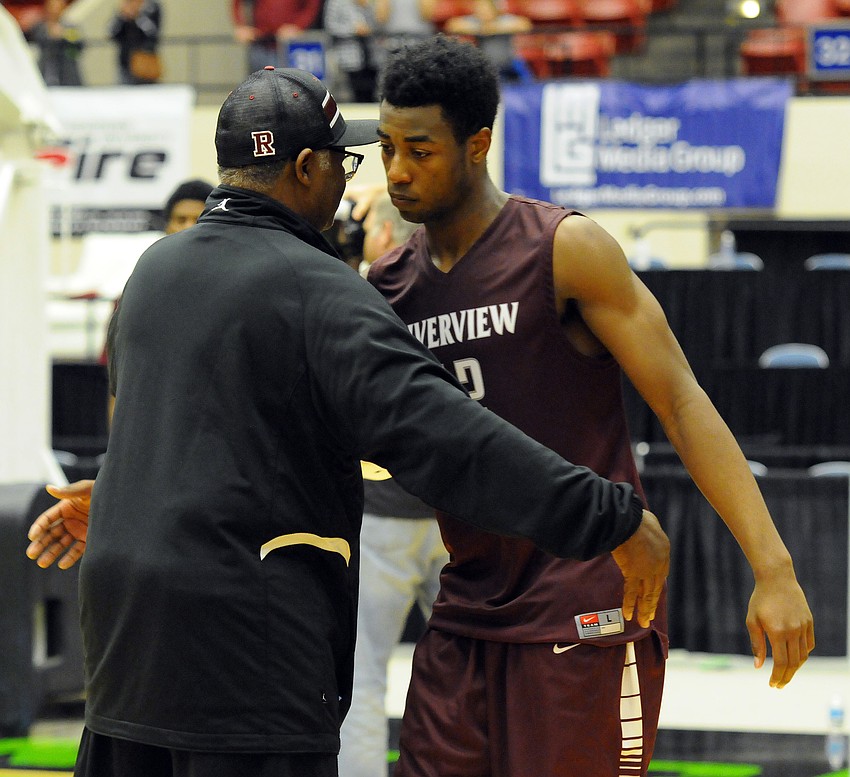 Riverview Athletic Director James Ward congratulates junior Brion Whitley on a historic season.