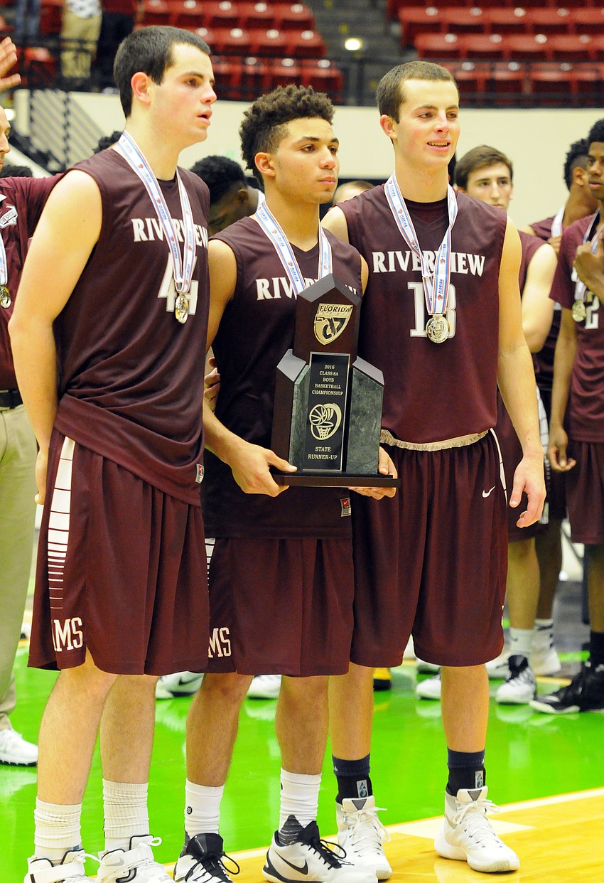 Riverview co-captains AJ Caldwell, D.J. Bryant and Dom Caldwell accept the Class 8A state runner-up trophy.