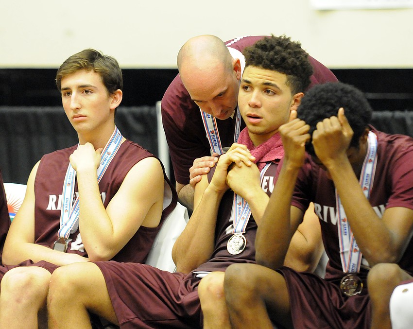 Riverview coach BJ Ivey talks to senior D.J. Bryant following the Rams' 61-57 loss to Coral Springs in the Class 8A state championship Feb. 27.