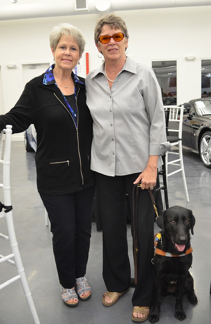 Lin Oakerson with artist and Southeastern Guide Dogs program graduate Cheryl Kinderknecht with Kennesaw.