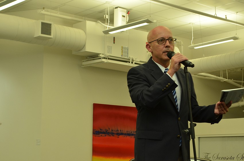 Southeastern Guide Dogs CEO Titus Herman addresses guests at the Superheroes on Parade launch party Monday evening at the Sarasota Studio Dimmitt Automotive Group showroom.