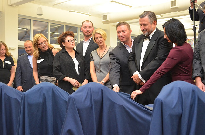 Sponsors prepare to reveal the first batch of statues for the Southeastern Guide Dogs Superheroes on Parade campaign.