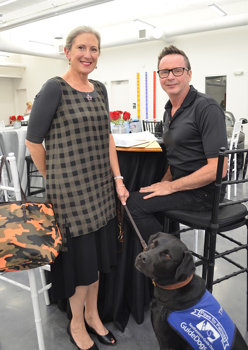 Yvonne Whitcomb with artist Brian Miller and Southeastern Guide Dogs ambassador Theo.