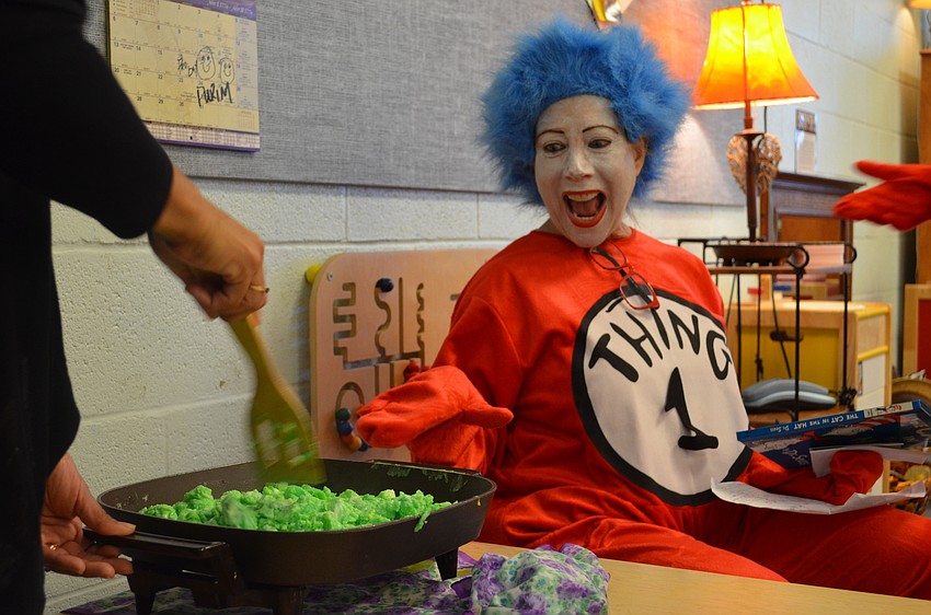 Rita Mazer as Thing 1 spots some freshly-made green eggs for the Dr. Seuss birthday celebration at Goldie Feldman Academy.