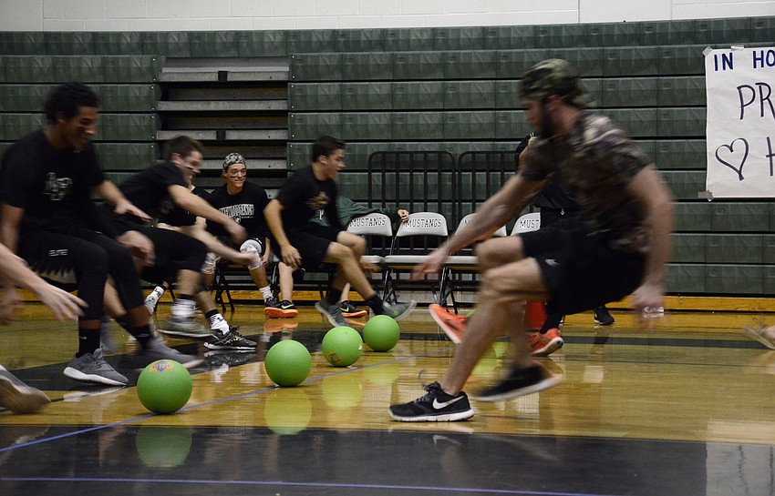 The Black Magic and Invisibles teams rush for the balls after the match began.