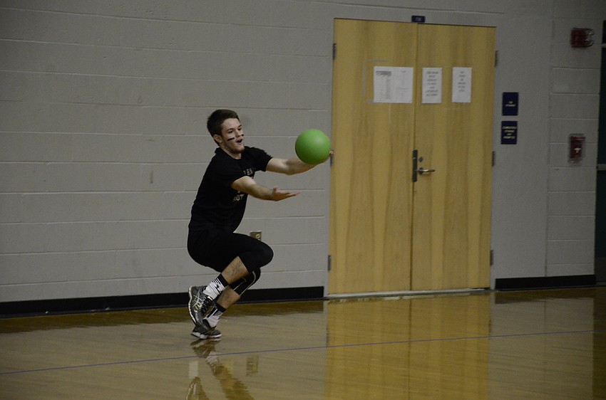 Tom Wolfe of the Black Magic team attempts to catch a ball. He was almost successful but tripped and dropped it at the last second.