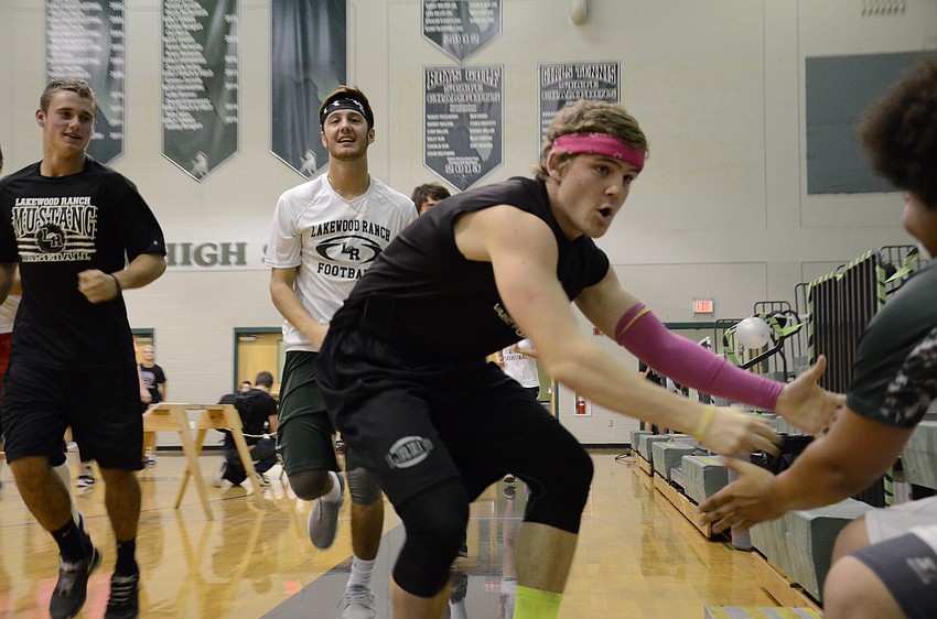 Justin Curtis, Trevor Losada and Cody Hendrickson with the Goons and Grads team get some crowd support.