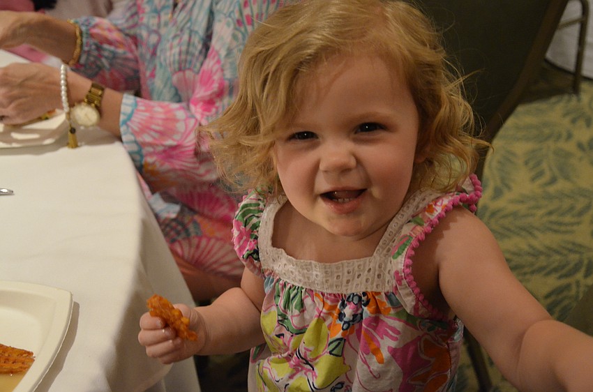 Adalyn Shaw of Sarasota eats a snack before her debut.