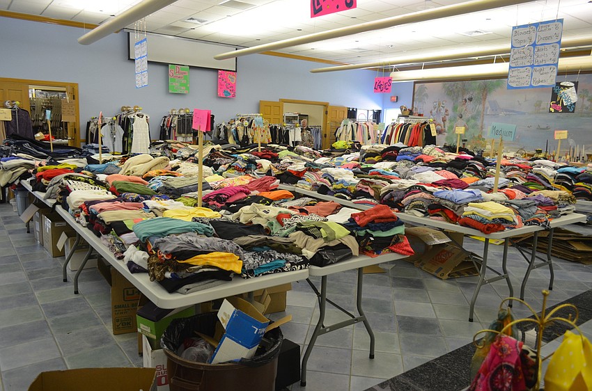 Volunteers organized clothing by size.