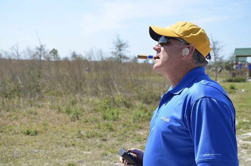 Jon Mast watches a clay for a team shooter.