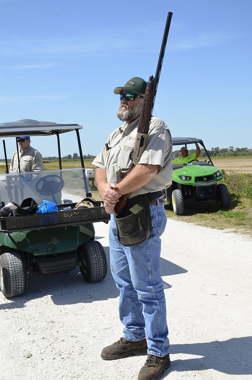 Ben King waits his turn with his gun ready on his hip.