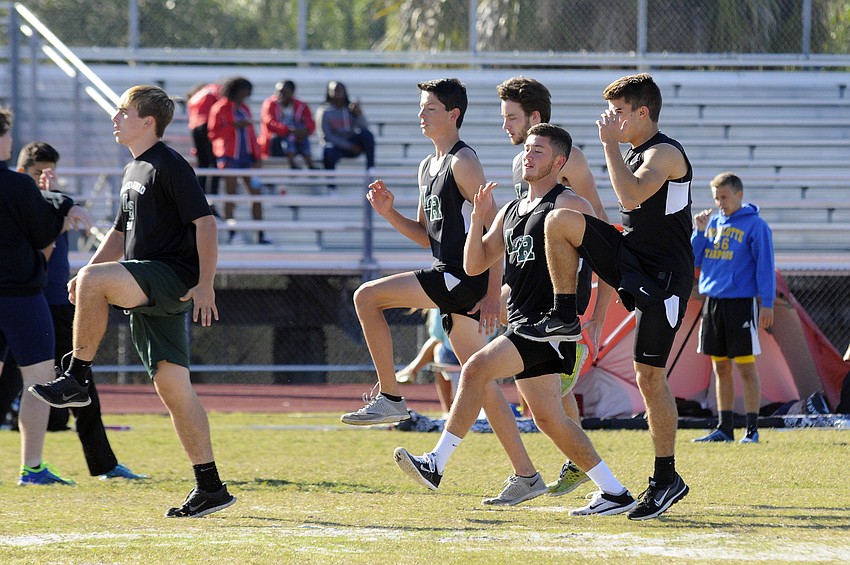 Members of the Lakewood Ranch boys track team warm up before the start of the running events.