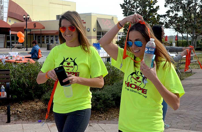 Sarah Scarlett and Kristina Barrow, of Bradenton, receive their medals after finishing the 3k.