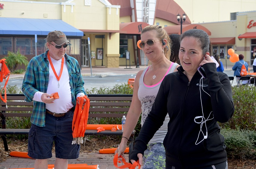 Adrianne Smith, of Lakewood Ranch, and Rachel Siditsky, of Sarasota, listen to music during their jog.