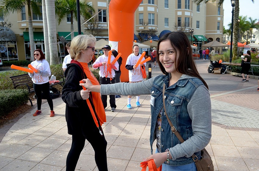 Lynn Gibson, of Lakewood Ranch, accepts her medal from Laura Poots, of Bradenton.