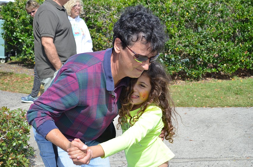 Chris Shamsey dances with her granddaughter Alice Nouri.