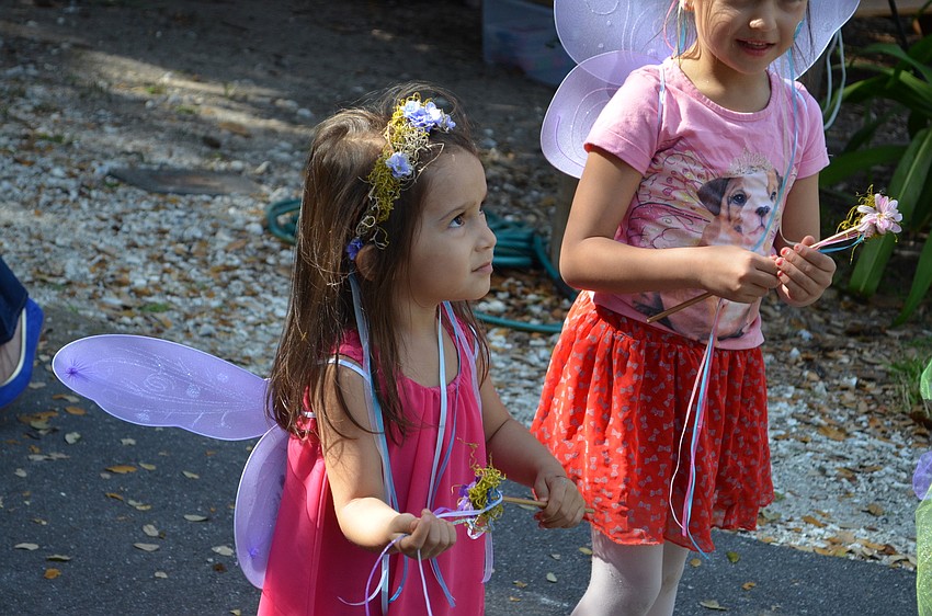 Leila  Schaedler-Luera pays close attention to Fairy of the Daisies Marilyn Schwartz on how to be a fairy.
