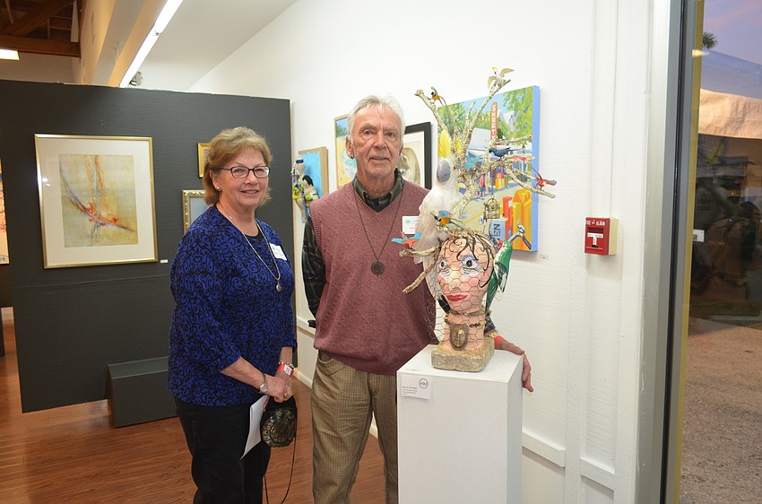 Artist David Chrobak, right, and wife, Donna, with Honorable Mention “I Hear Strange Voices”