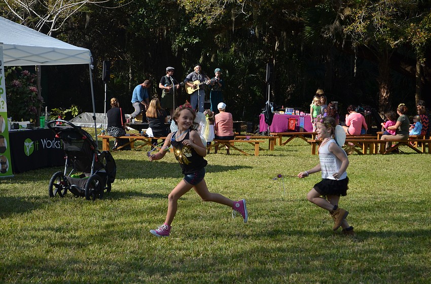Aspen Peterich and Mayla Austin frolic on the lawn as fairies.