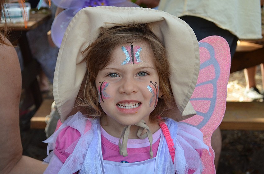 Bz Svvor shows off her butterfly face paint to match her wings.