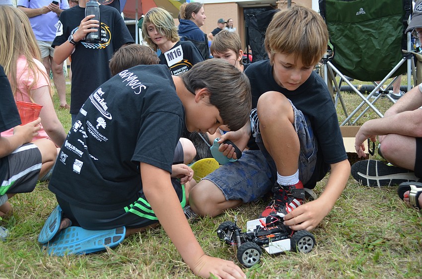 Evan Angeleri and Colin Desvain make adjustments to their car.