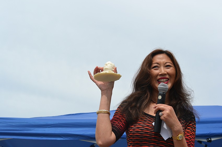 Suncoast Science Center Executive Director Ping Faulhaber holds up a 3-D printed version of founds Fritz Faulhaber for the crowd to see.