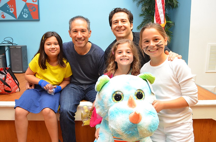 Naomi and David Yamada with Steven, Lanie and Samantha Fineman. Lanie Fineman used her tickets from playing carnival games to earn her stuffed rhinoceros.