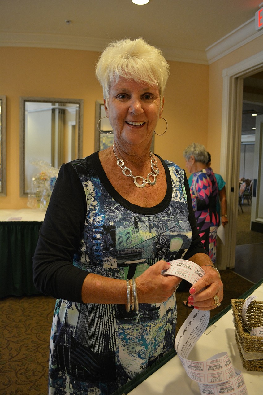 Nancy Nagy sells raffle tickets to guests.