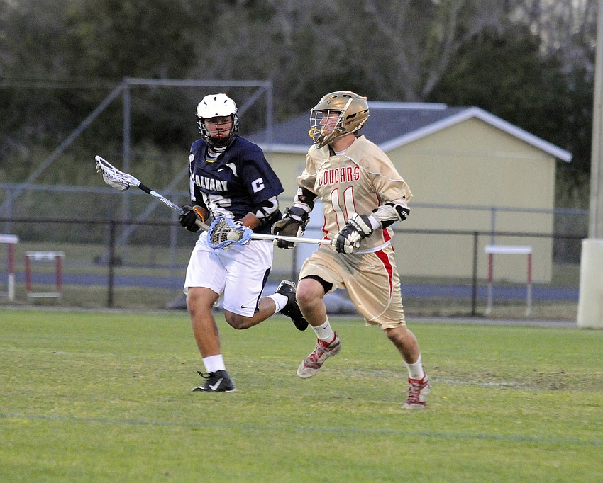 Cardinal Mooney sophomore Patrick Kenefick attempts to maneuver past a Calvary Christian defender.