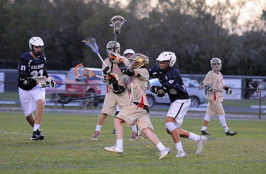 Cardinal Mooney freshman Connor Nicholson muscles his way toward the goal.