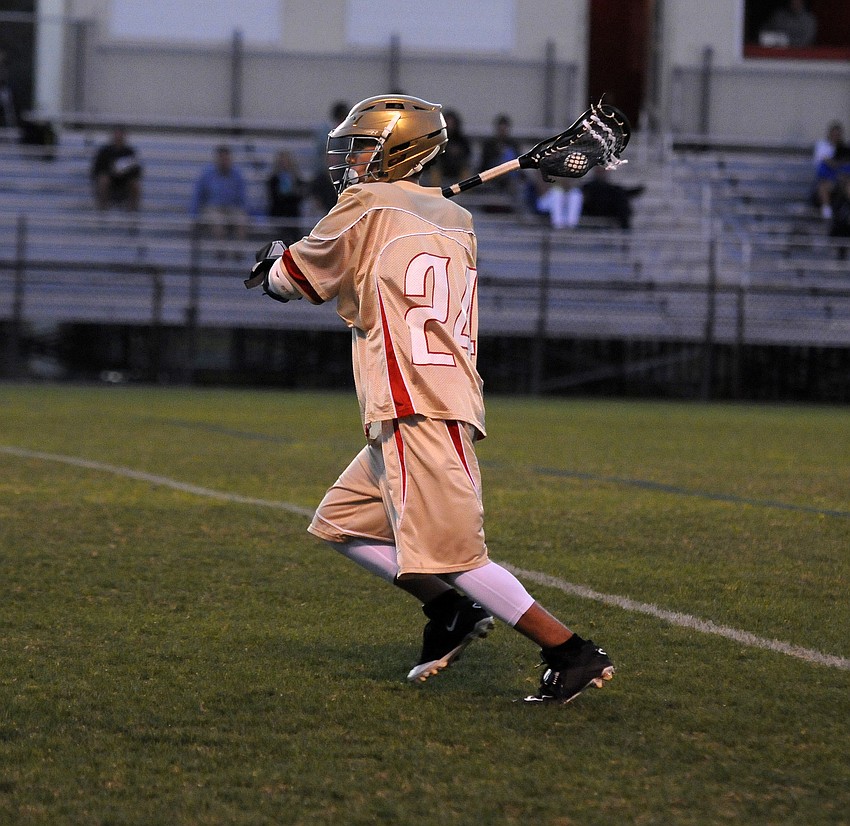 Cardinal Mooney sophomore Zach Kelly looks to pass the ball up the field.